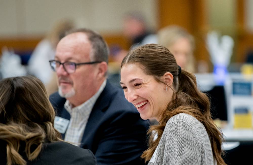 Women laughing at the Secchia Breakfast Lecture on Jan 27, 2023